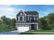 Charming two-story home with gray siding, white trim, a two-car garage, and manicured landscaping at 641 Emerald Bay Cir, Raleigh, NC 27610