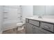 Clean bathroom with a tub and shower, along with a single sink vanity featuring grey cabinets at 68 Commons Cir # 223, Clayton, NC 27520
