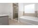 Bathroom with a glass-door shower and separate soaking tub at 68 Commons Cir # 223, Clayton, NC 27520