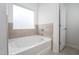 Bathroom with soaking tub and tile surround at 68 Commons Cir # 223, Clayton, NC 27520