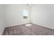 Bright bedroom features neutral walls, carpet flooring, and a window allowing for ample natural light at 68 Commons Cir # 223, Clayton, NC 27520