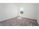 Bright bedroom features neutral walls, carpet flooring, and a window allowing for ample natural light at 68 Commons Cir # 223, Clayton, NC 27520