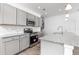 Modern kitchen with granite countertops, stainless steel appliances, and stylish cabinetry at 68 Commons Cir # 223, Clayton, NC 27520