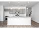 Modern kitchen features gray cabinets, stainless steel appliances, and granite countertops at 68 Commons Cir # 223, Clayton, NC 27520