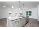 Modern kitchen island with granite countertop and stainless steel appliances at 68 Commons Cir # 223, Clayton, NC 27520