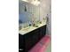A bathroom with double sinks and bright pink rugs at 70 Maxwell Pl, Lillington, NC 27546