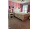 A vibrant bedroom showcasing colorful walls, a bed, and charming decorations at 70 Maxwell Pl, Lillington, NC 27546