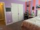 A well-lit bedroom with vibrant walls and ample closet space at 70 Maxwell Pl, Lillington, NC 27546
