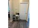 Hallway with gray wood floors, white trim and front door, neutral walls at 70 Maxwell Pl, Lillington, NC 27546