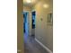 This carpeted hallway has decorated walls, a glimpse of a bedroom and leads to a closet at 70 Maxwell Pl, Lillington, NC 27546