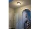 Hallway featuring archway, neutral walls and floors, and a white door at 70 Maxwell Pl, Lillington, NC 27546