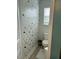 A stylish powder room featuring bold wallpaper and natural light from the window at 70 Maxwell Pl, Lillington, NC 27546