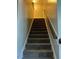 Carpeted staircase with handrail providing safe access to the next level of the home at 70 Maxwell Pl, Lillington, NC 27546