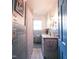 Well-lit bathroom with a modern vanity, decorative mirror, and tiled shower curtain at 711 Stuart Dr, Sanford, NC 27330