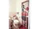 Bathroom featuring a toilet and a shower/tub with a modern patterned curtain at 711 Stuart Dr, Sanford, NC 27330