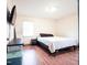 Cozy bedroom with wood flooring features a TV, dresser, mirror and comfortable bed at 711 Stuart Dr, Sanford, NC 27330