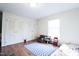 Bright bedroom features hardwood floors, closet, a window with blind, and decor at 711 Stuart Dr, Sanford, NC 27330