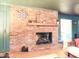 Classic brick fireplace with a decorative mantel, perfect for cozy evenings at 711 Stuart Dr, Sanford, NC 27330