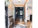 Stylish foyer with hardwood floors, patterned wallpaper, and a charming wooden bench at 711 Stuart Dr, Sanford, NC 27330