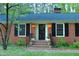 Inviting front entrance with brick steps, decorative lights, and a charming wreath at 711 Stuart Dr, Sanford, NC 27330