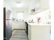 Bright kitchen with stainless steel appliances, white cabinets, and ample counter space at 711 Stuart Dr, Sanford, NC 27330