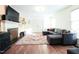 Bright living room with a fireplace, and a plush sectional sofa on a decorative rug at 711 Stuart Dr, Sanford, NC 27330