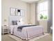 A bright bedroom featuring soft colors, a large window, and stylish bedside tables with modern lamps at 806 Hyperion Aly, Wake Forest, NC 27587