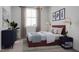Comfortable bedroom featuring a large window, neutral walls, and a queen-size bed with decor at 806 Hyperion Aly, Wake Forest, NC 27587