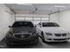 Spacious two-car garage featuring a newly installed garage door and two parked cars at 806 Hyperion Aly, Wake Forest, NC 27587