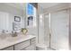 Elegant bathroom features a glass-enclosed shower, marble walls, and a vanity with modern fixtures at 812 Emerald Bay Cir, Raleigh, NC 27610