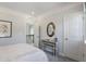 Neutral bedroom with a view of the staircase, modern decor, and a round mirror above a console table at 812 Emerald Bay Cir, Raleigh, NC 27610