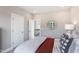 Comfortable bedroom showcases neutral tones, an adjacent view to the staircase, and a bright window at 812 Emerald Bay Cir, Raleigh, NC 27610