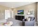 Modern living room with entertainment center, neutral walls, and comfortable seating arrangement at 812 Emerald Bay Cir, Raleigh, NC 27610