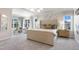 Luxurious main bedroom with a sitting area, tufted headboard, and plenty of natural light from large windows at 812 Emerald Bay Cir, Raleigh, NC 27610