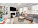 Comfortable living room featuring a fireplace, built-in shelving, and lots of natural light at 8124 Primanti Blvd, Raleigh, NC 27612