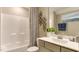 Well-lit bathroom featuring a shower, vanity with sleek sink, decorative accents and modern fixtures at 840 Emerald Bay Cir, Raleigh, NC 27610