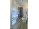 Bathroom featuring wood-look flooring, and a floating shelving unit at 905 Spruce Pine Trl, Durham, NC 27705