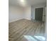 A bright bedroom featuring modern flooring and a convenient closet for storage at 905 Spruce Pine Trl, Durham, NC 27705
