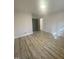 Bedroom featuring wood-look flooring, neutral walls, and minimalist trim at 905 Spruce Pine Trl, Durham, NC 27705