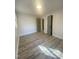 Bedroom with wood-look flooring and neutral paint, illuminated by recessed lighting at 905 Spruce Pine Trl, Durham, NC 27705