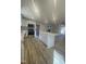 Bright kitchen features a center island, stainless steel appliances, and wood-look flooring at 905 Spruce Pine Trl, Durham, NC 27705