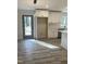 Open concept kitchen with stainless steel appliances, white cabinetry, and a view to the backyard at 905 Spruce Pine Trl, Durham, NC 27705