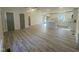 Spacious open-concept kitchen featuring new wood-look floors, a center island, and bright white cabinetry at 905 Spruce Pine Trl, Durham, NC 27705
