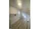 Bright laundry room with shelving, window and modern wood-look flooring at 905 Spruce Pine Trl, Durham, NC 27705