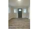 Bright living room boasts wood-look floors and modern trim, showcasing a serene and minimalist aesthetic at 905 Spruce Pine Trl, Durham, NC 27705
