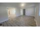 Bright, open-concept living area with neutral walls and modern wood-look flooring throughout the home at 905 Spruce Pine Trl, Durham, NC 27705