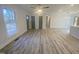 Open-concept living area with gray doors, a ceiling fan, and wood-look flooring at 905 Spruce Pine Trl, Durham, NC 27705