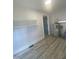 Clean utility room with shelves, modern wood-look flooring, and a new water heater at 905 Spruce Pine Trl, Durham, NC 27705