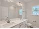 Bright bathroom featuring double sinks, white cabinets, and large mirror at 924 Jasper Mine Trl, Raleigh, NC 27610