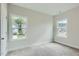 Bright bedroom features soft carpet and two windows offering natural light and neighborhood views at 924 Jasper Mine Trl, Raleigh, NC 27610